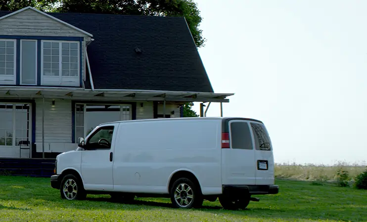 Van parked outside of residential home