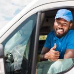 Driver smiling in customized wprk van