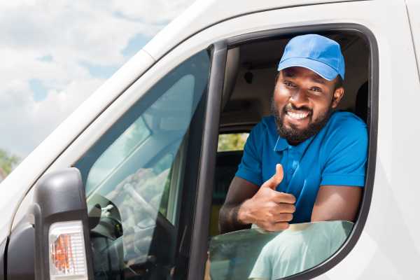 Driver smiling in customized wprk van